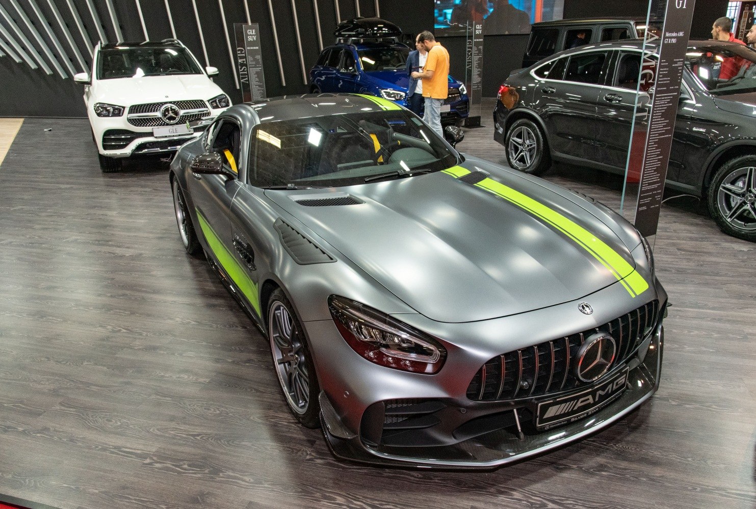 Matte finish sports coupe with bold racing stripe and aggressive front grille.