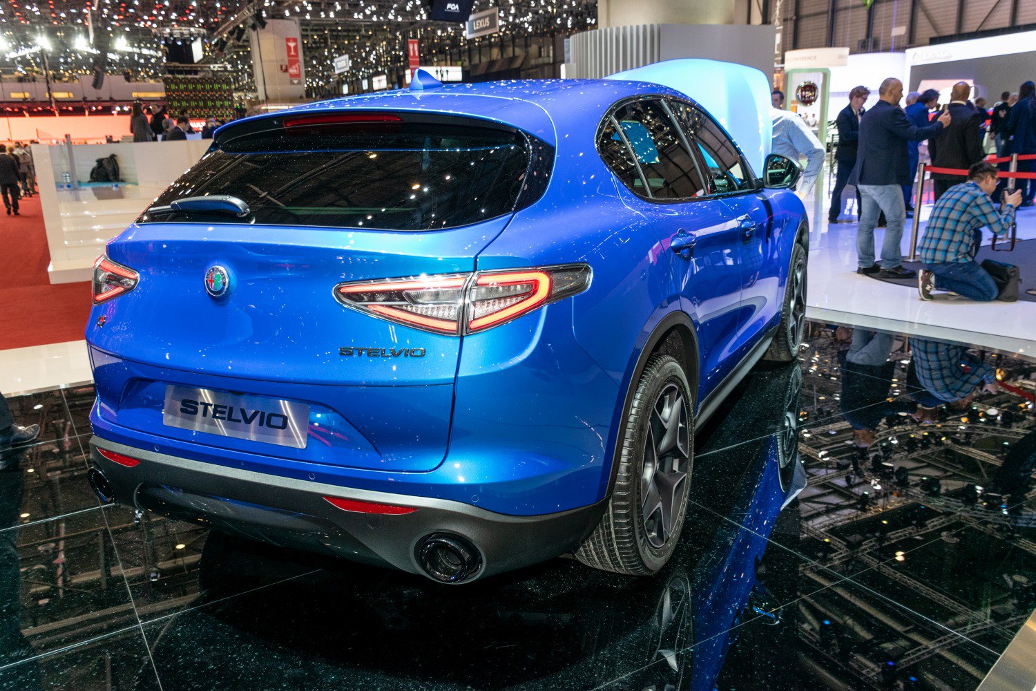 Rear view of blue SUV with distinctive taillights and dual exhausts
