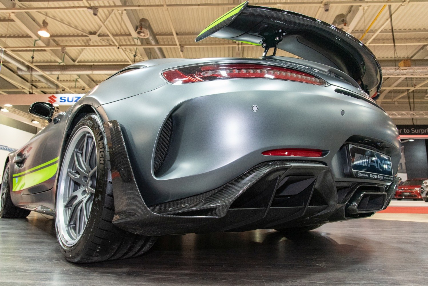 Rear view of a sports car with carbon fiber diffuser and raised rear spoiler