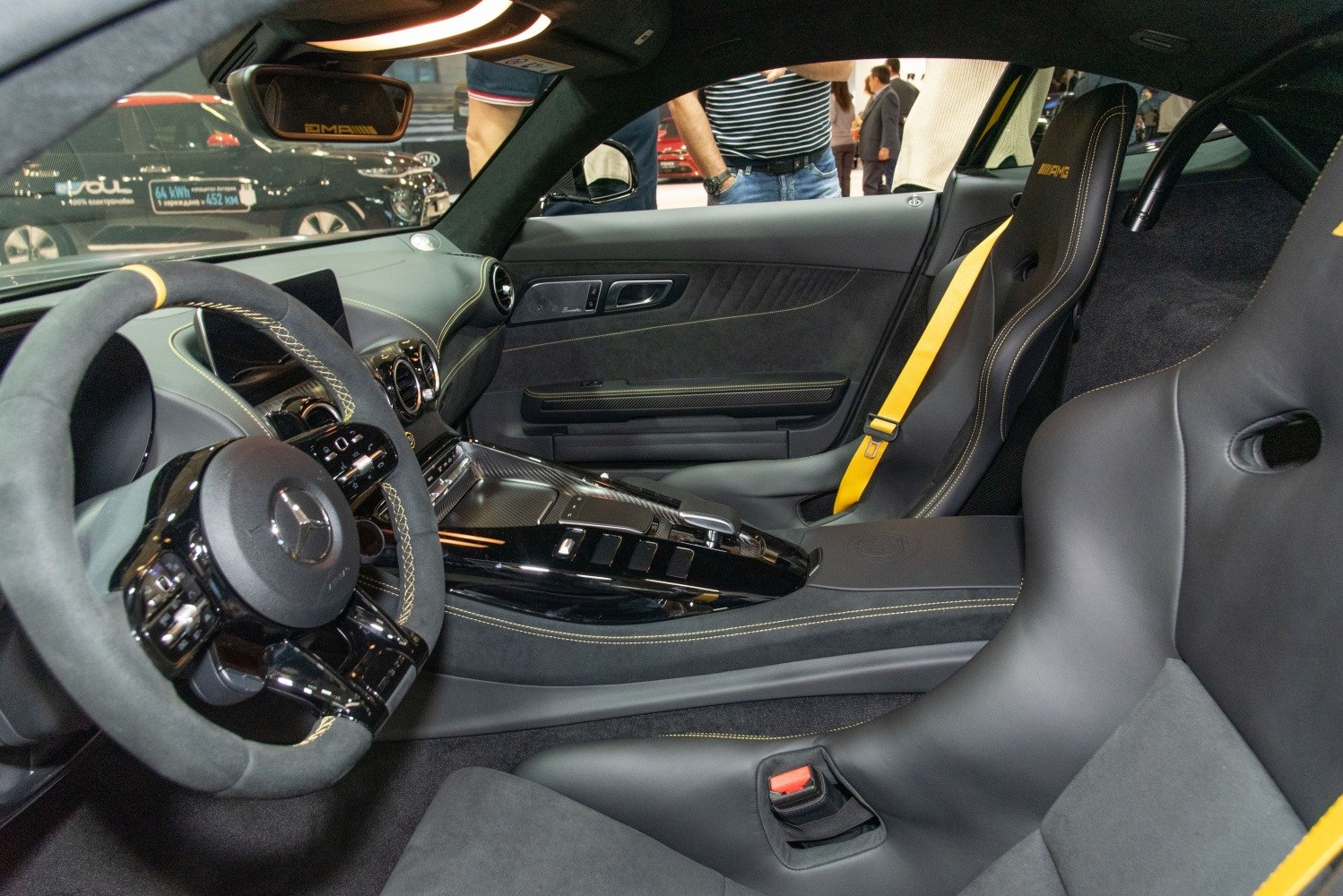 Sports seats with yellow belts and carbon fiber center console