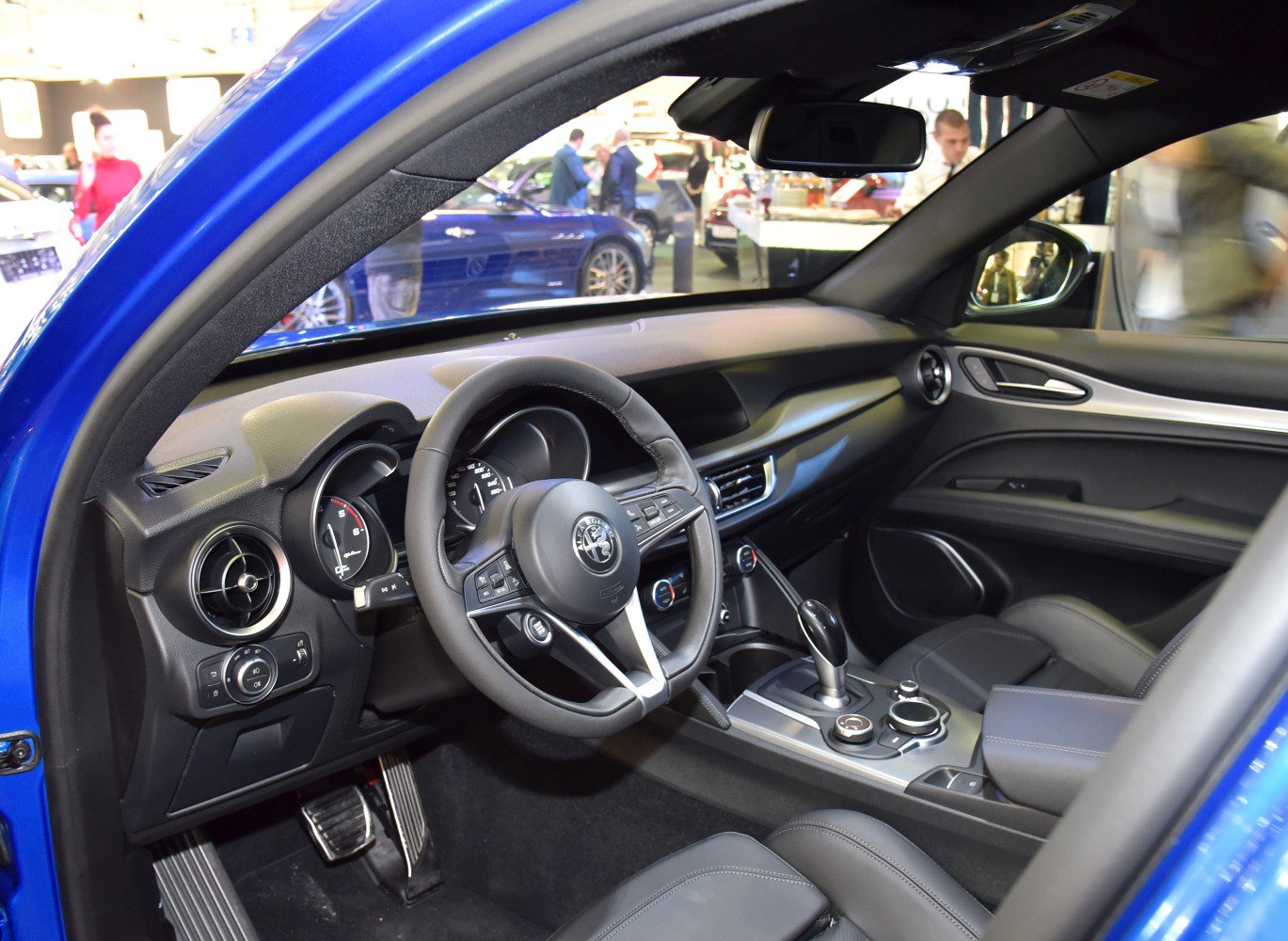 Luxury car interior with steering wheel, dashboard, and gear shifter