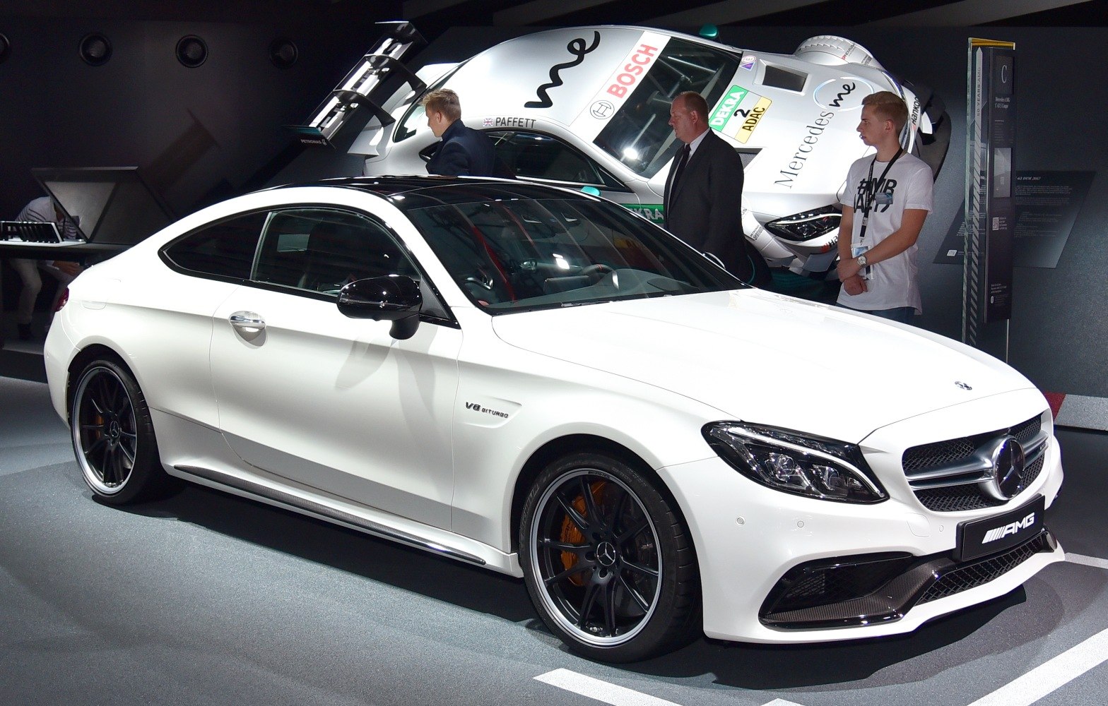 White luxury coupe with V8 Biturbo badge and sporty wheels
