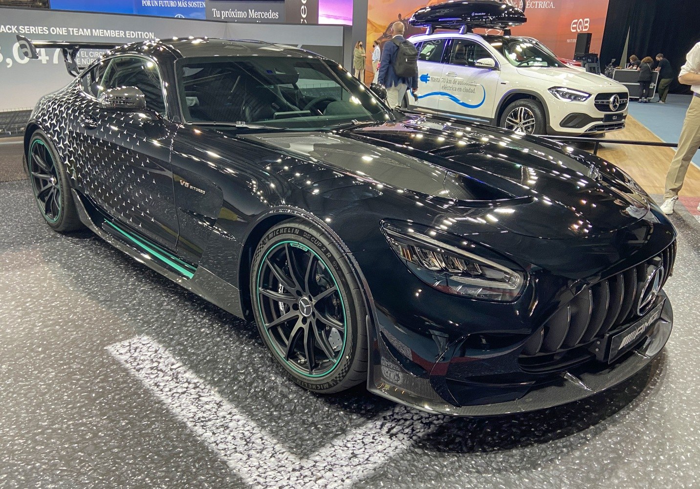 Black sports coupe with V8 Biturbo badge and aerodynamic front splitter