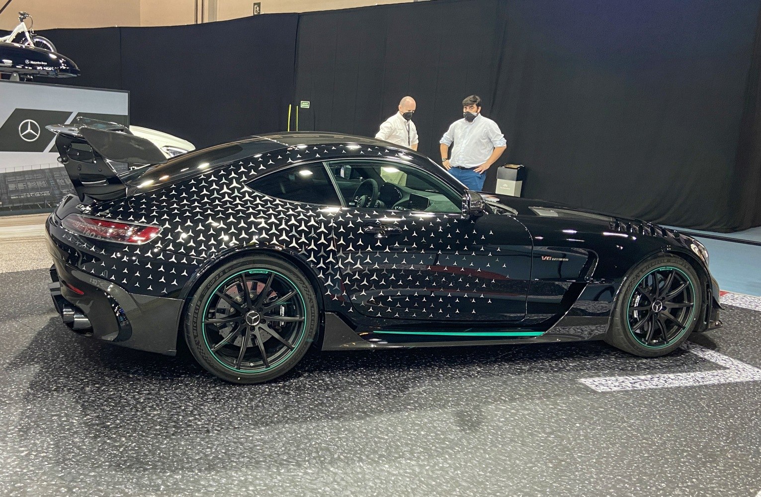 Side view of AMG GT with large rear wing and star-pattern body design
