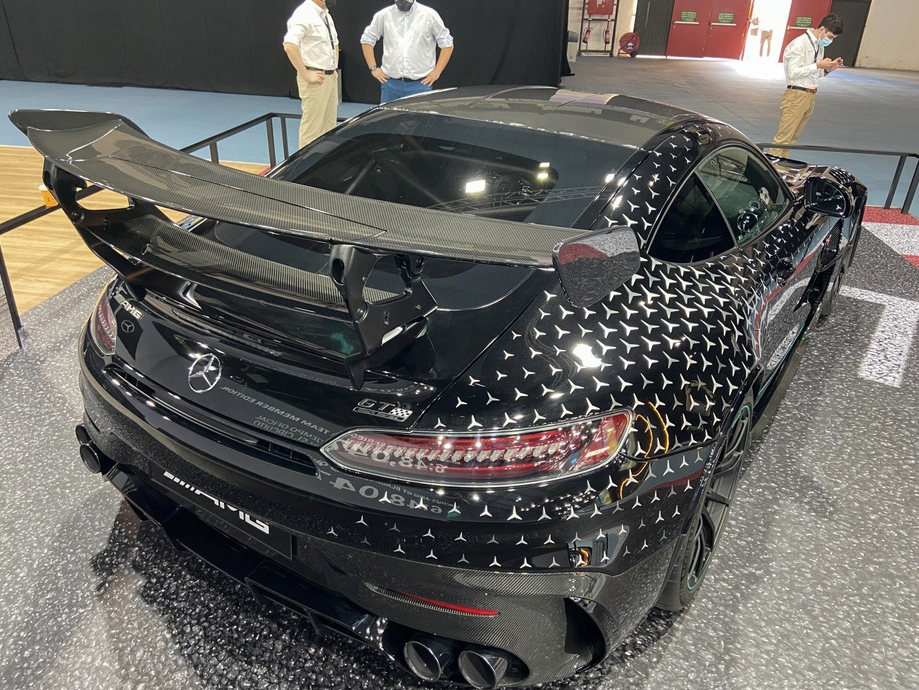 Carbon fiber rear wing and patterned rear body with quad exhausts