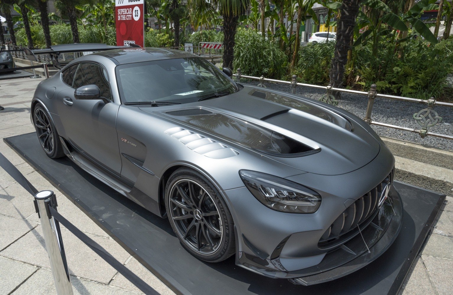 Matte gray sports coupe with aggressive aero kit and V8 biturbo badging