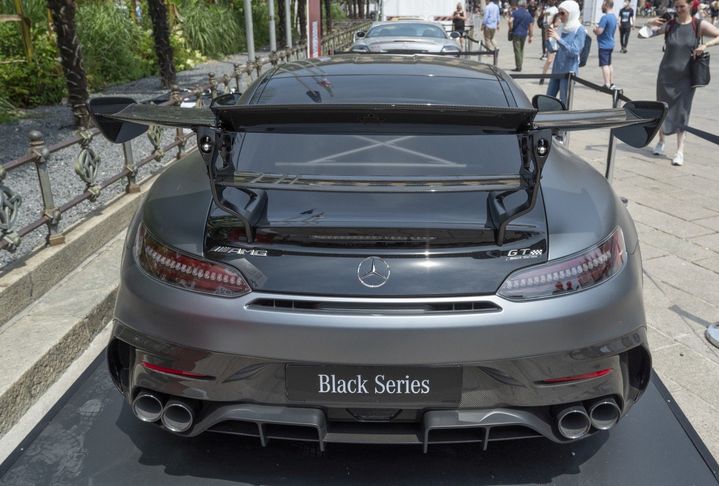 Rear of AMG GT with prominent carbon fiber spoiler and quad exhausts