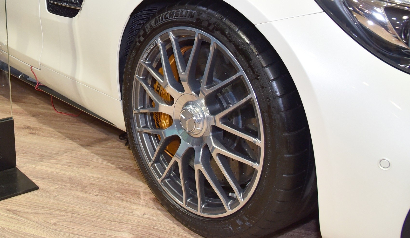 Detailed alloy wheel and yellow brake caliper on sporty wheel