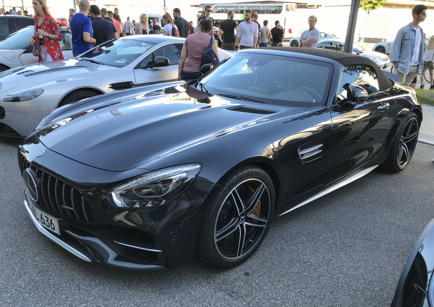 Convertible sports car with prominent front grille and hood vents