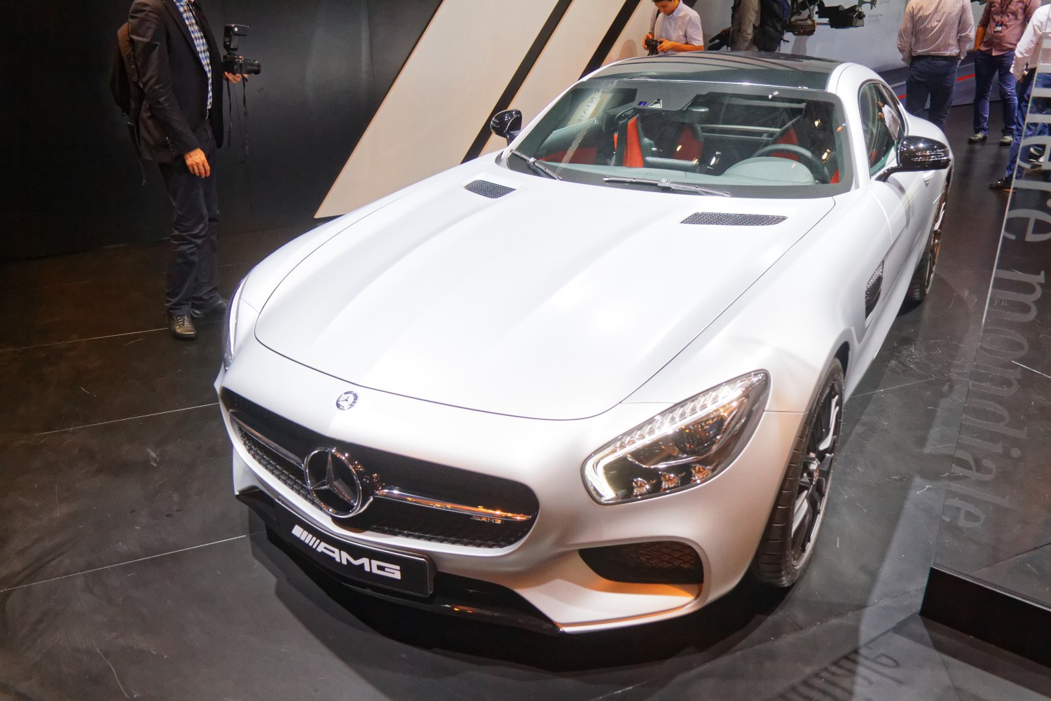 Front view of a luxury sports car with LED headlights and dual hood vents
