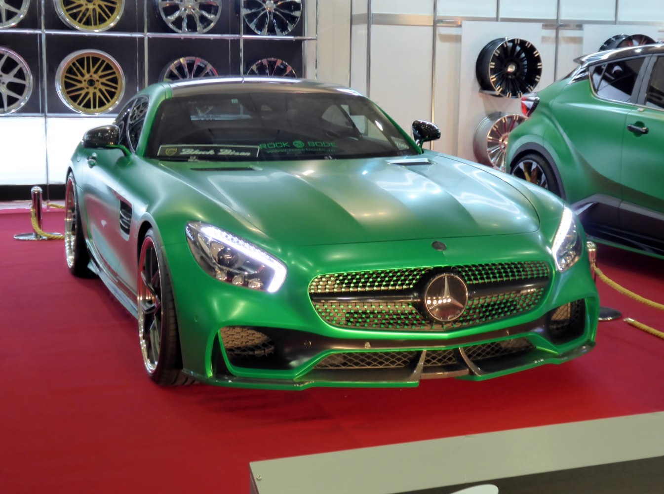 Green sports coupe with LED headlights and detailed front grille