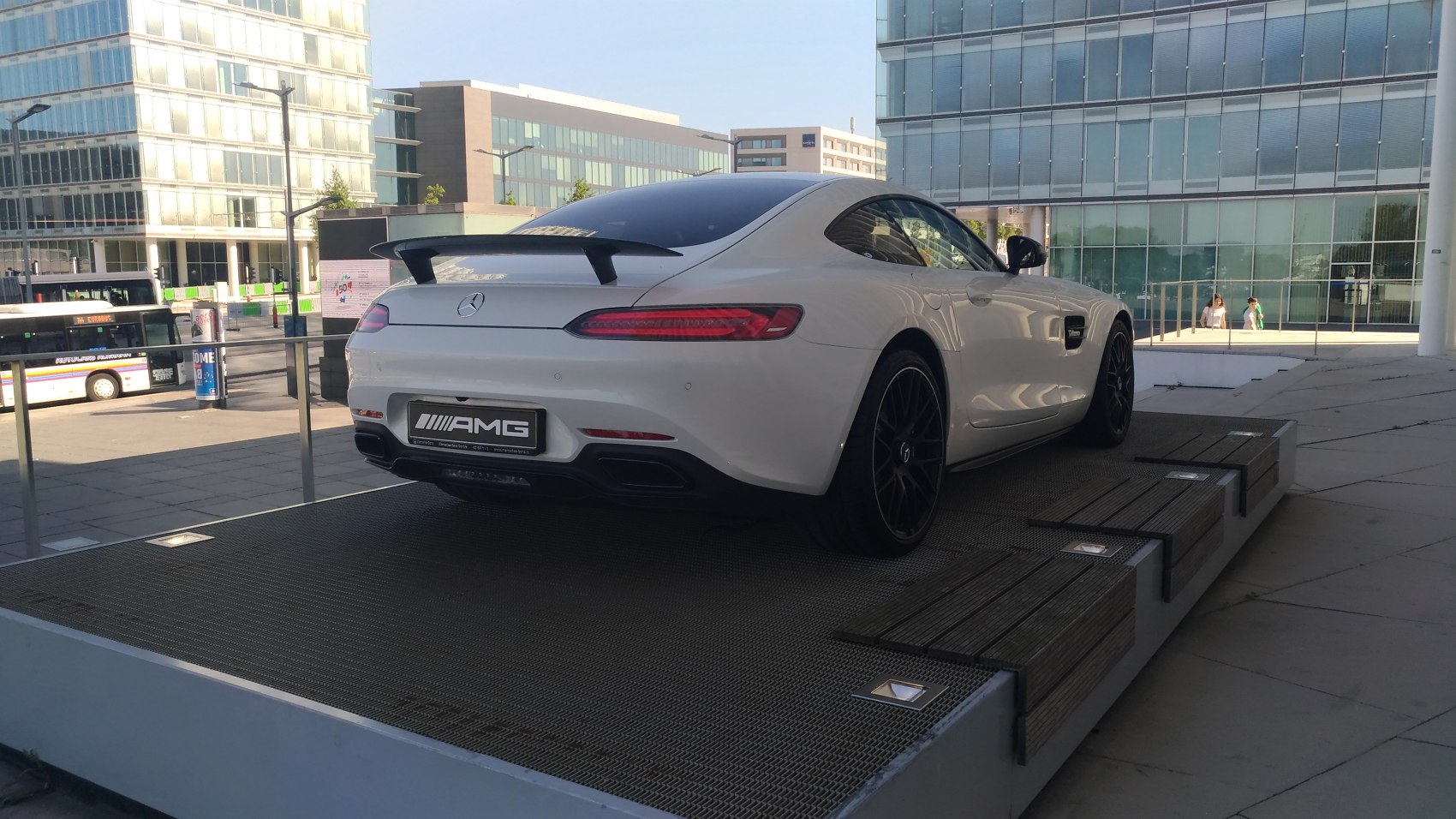 Rear angled view with rear spoiler and black alloy wheels