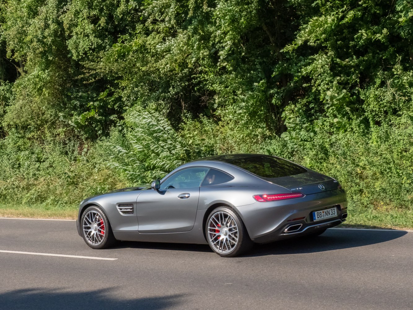 Sleek rear and side profile of a sports coupe with sporty wheels and aerodynamic design