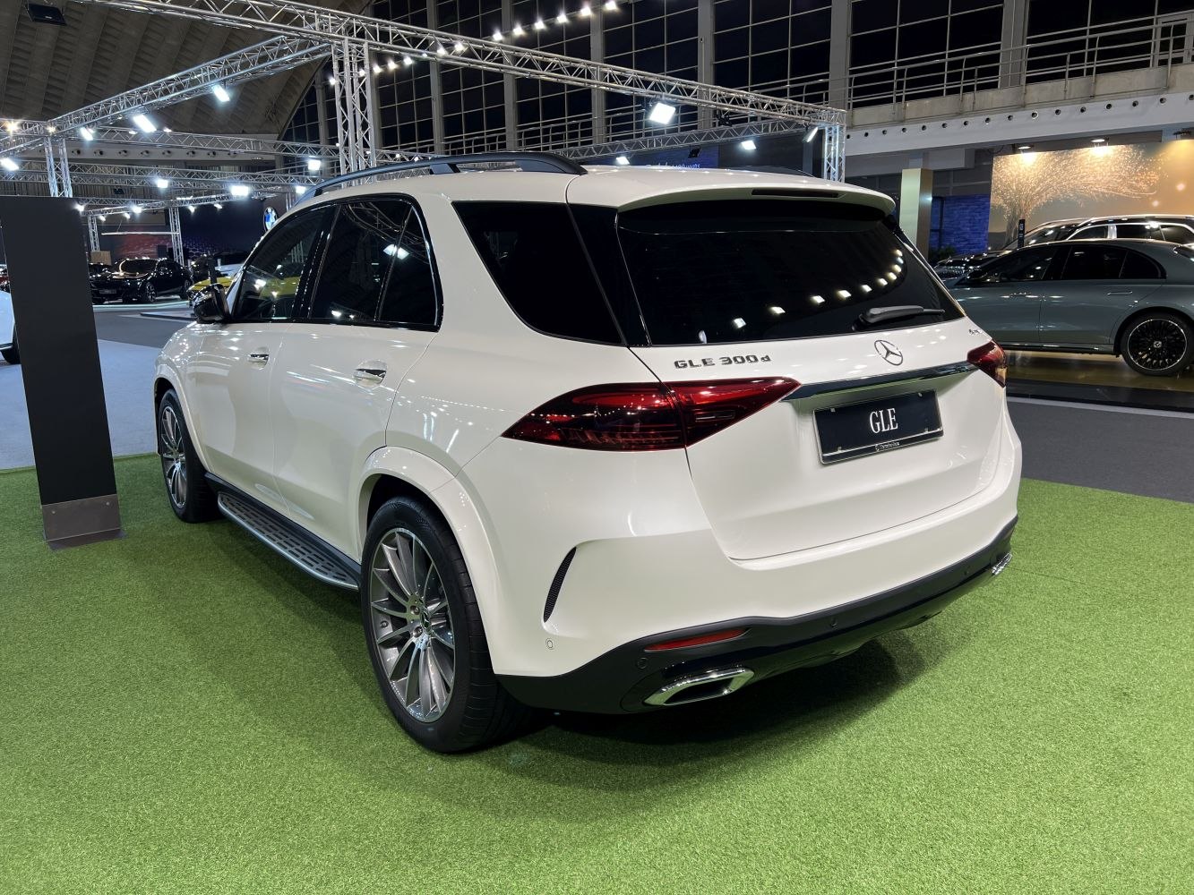 Rear view of a luxury mid-size SUV with sleek tail lights and dual exhausts