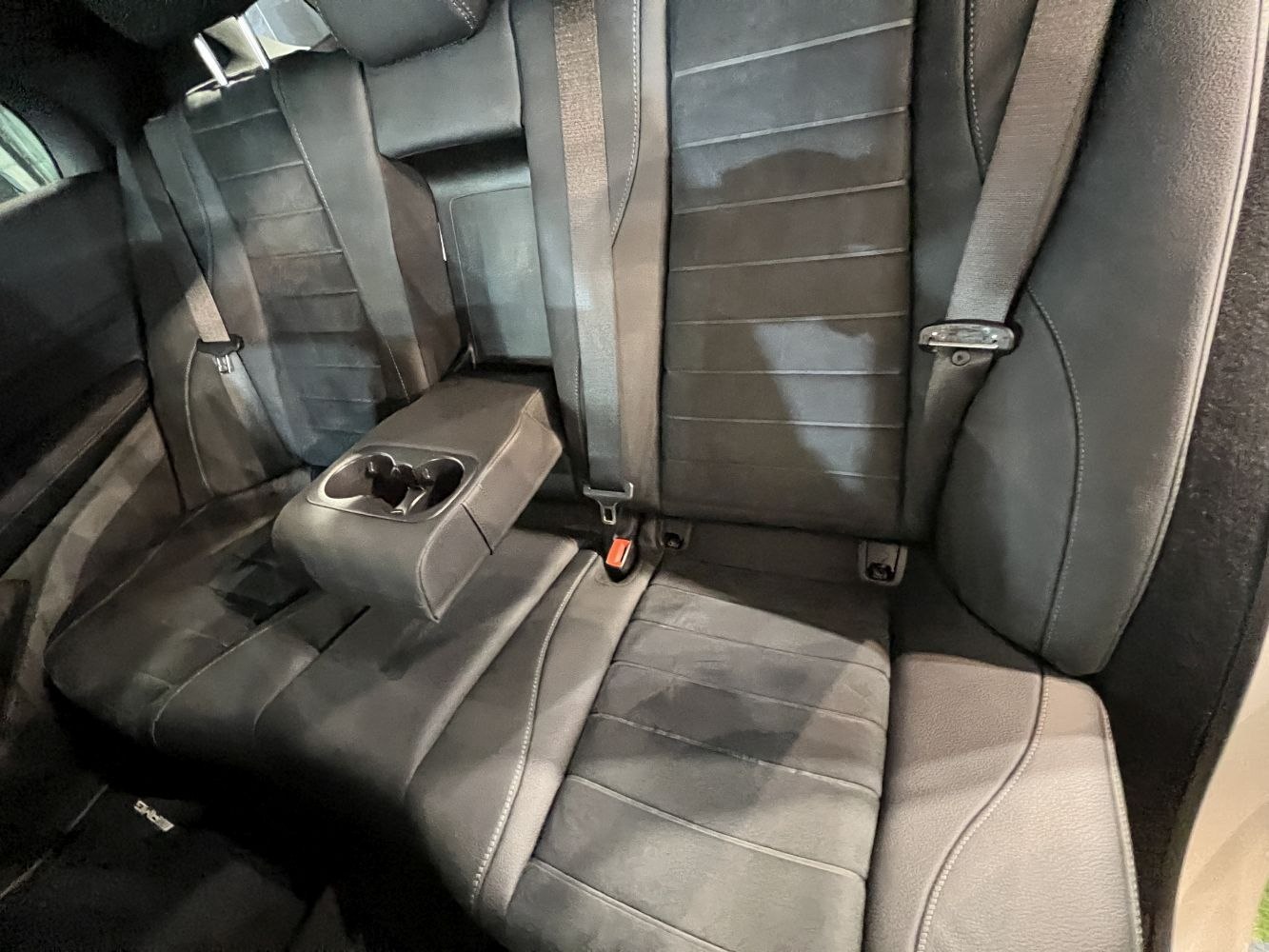 Rear black leather seats with foldable armrest and cup holders