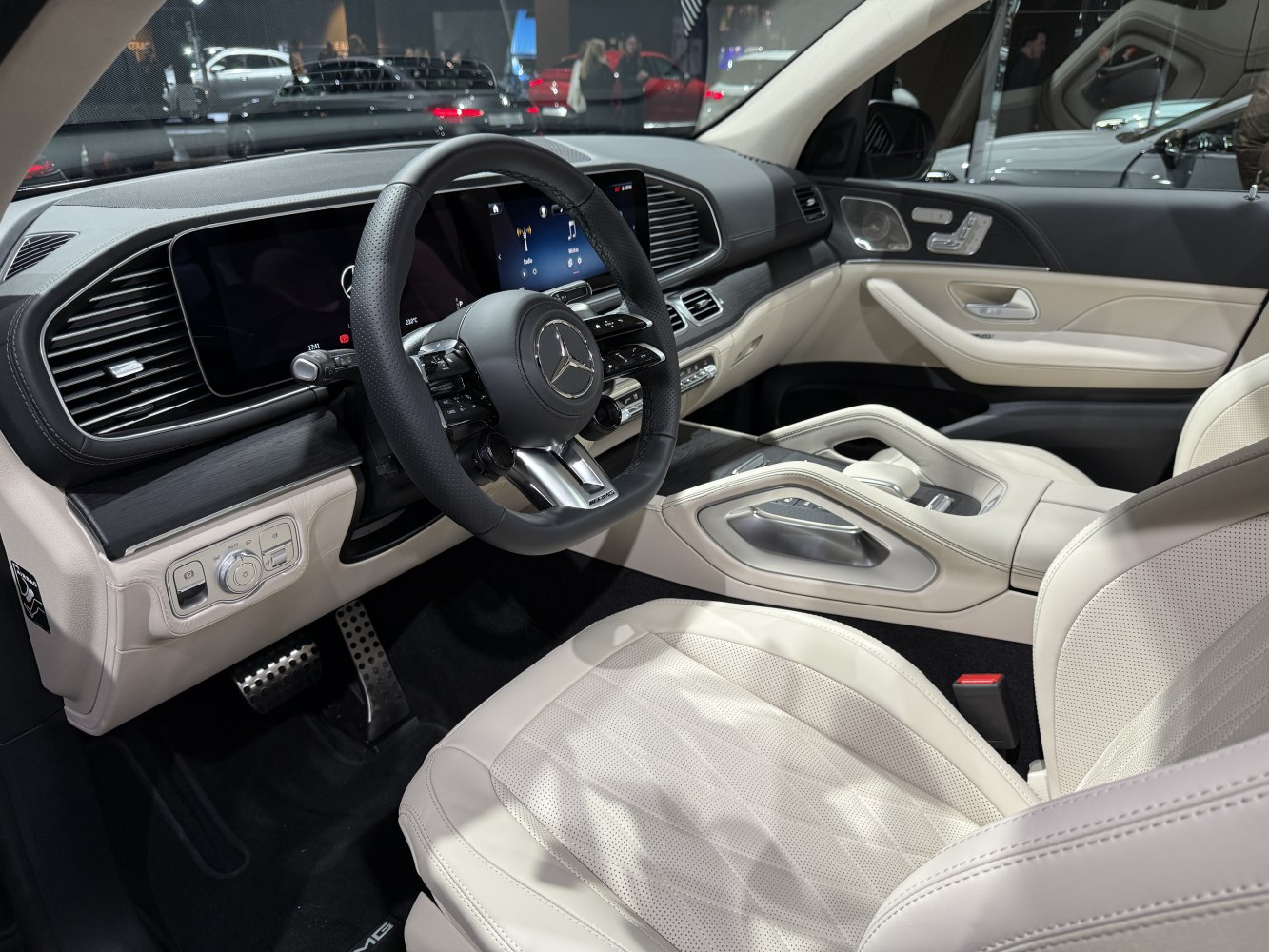Luxury SUV interior with AMG steering wheel and dual digital displays