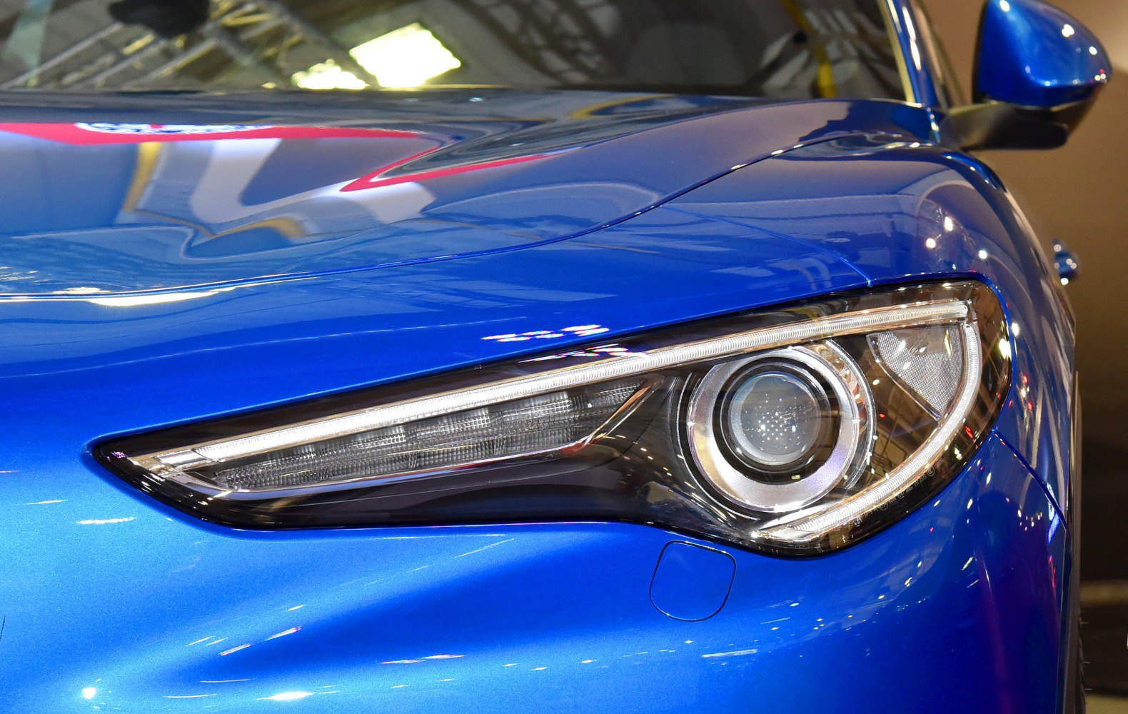 Sharp headlight and glossy blue hood with side mirror
