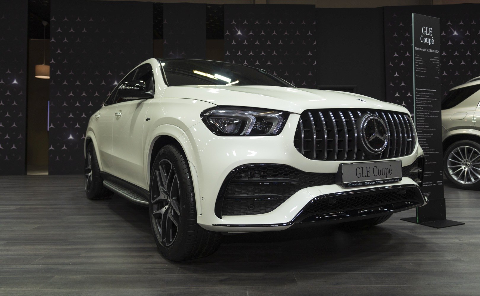 Front side view of luxury SUV with vertical grille and LED headlights