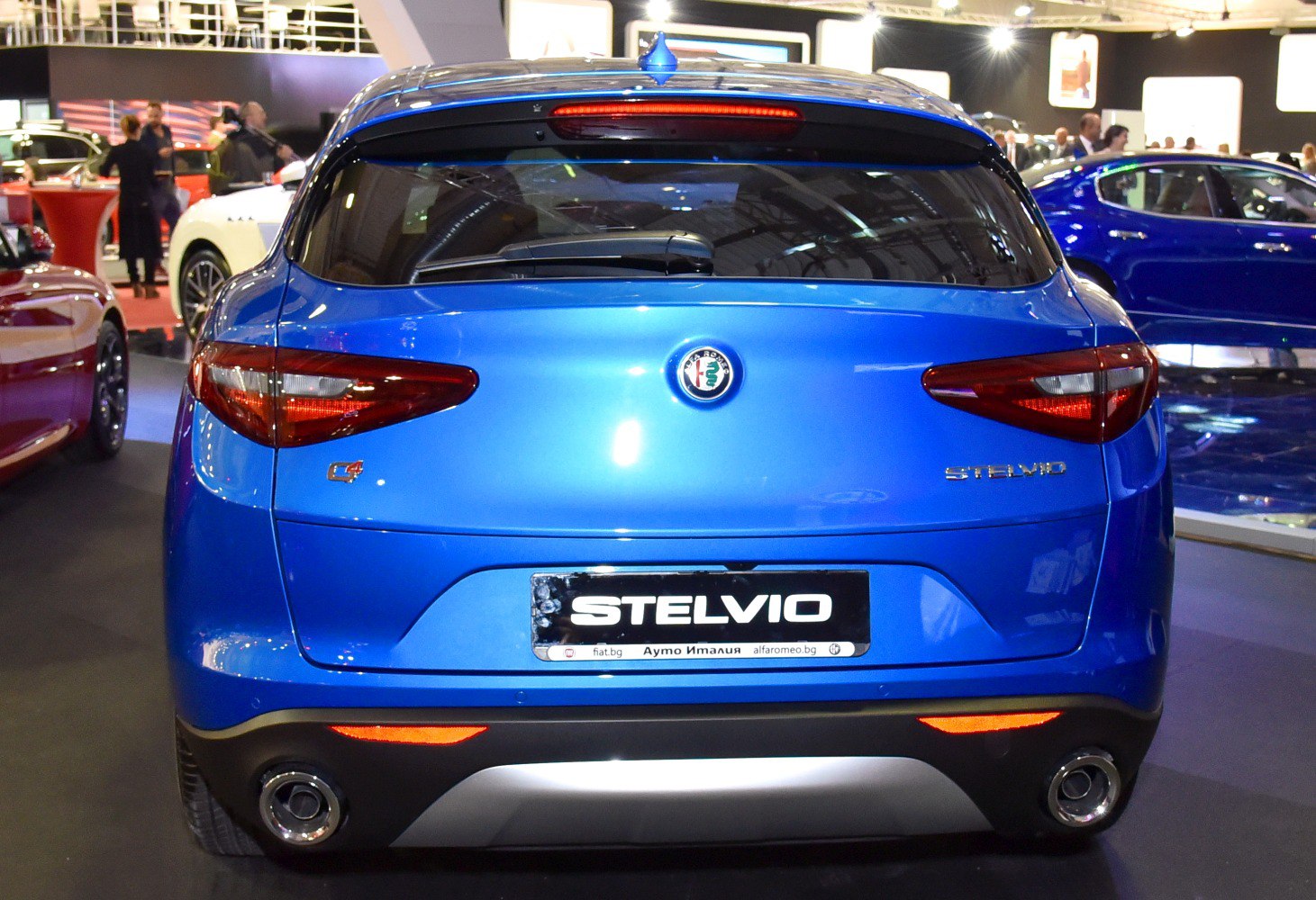 Rear view of blue SUV with distinctive taillights and dual exhaust pipes