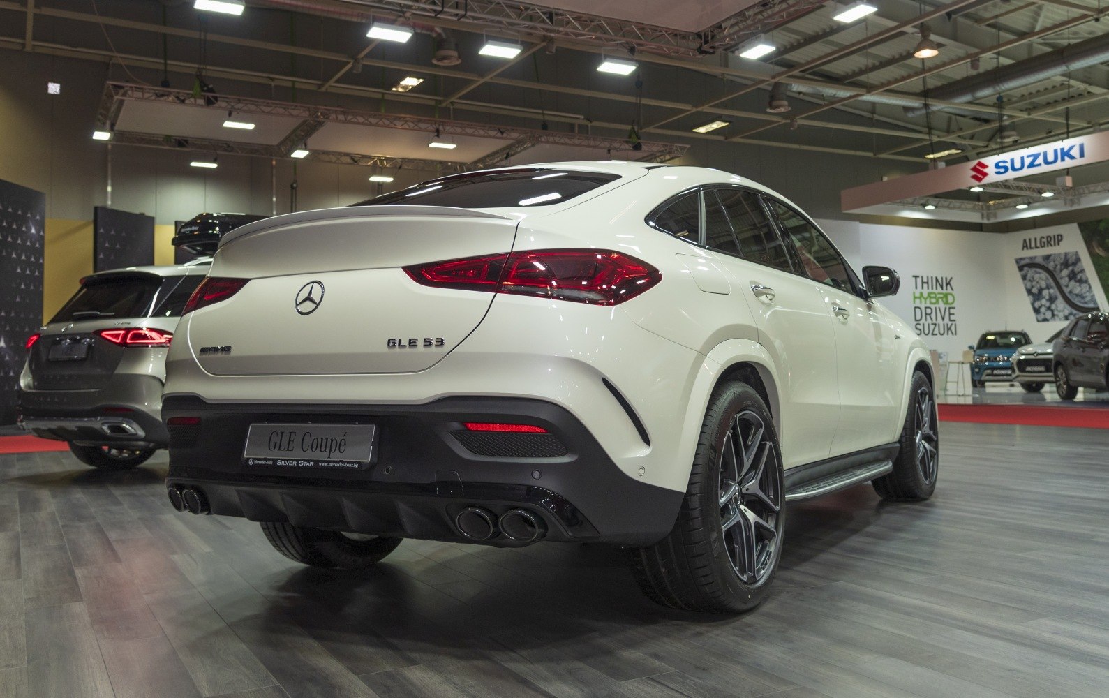 Luxury coupe SUV rear with quad exhausts and LED taillights