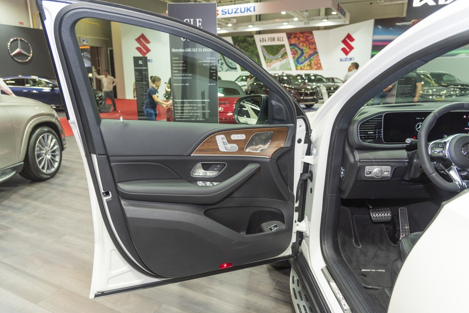 Door panel with wood trim and advanced dashboard controls in luxury SUV