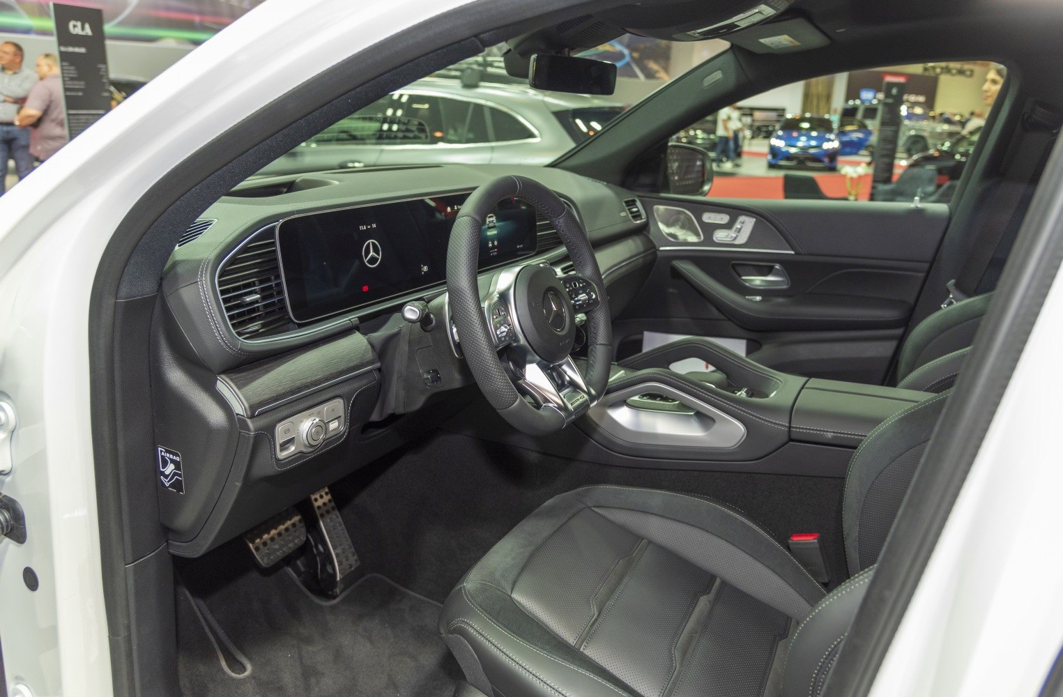 Modern car interior with digital dashboard and advanced steering wheel controls