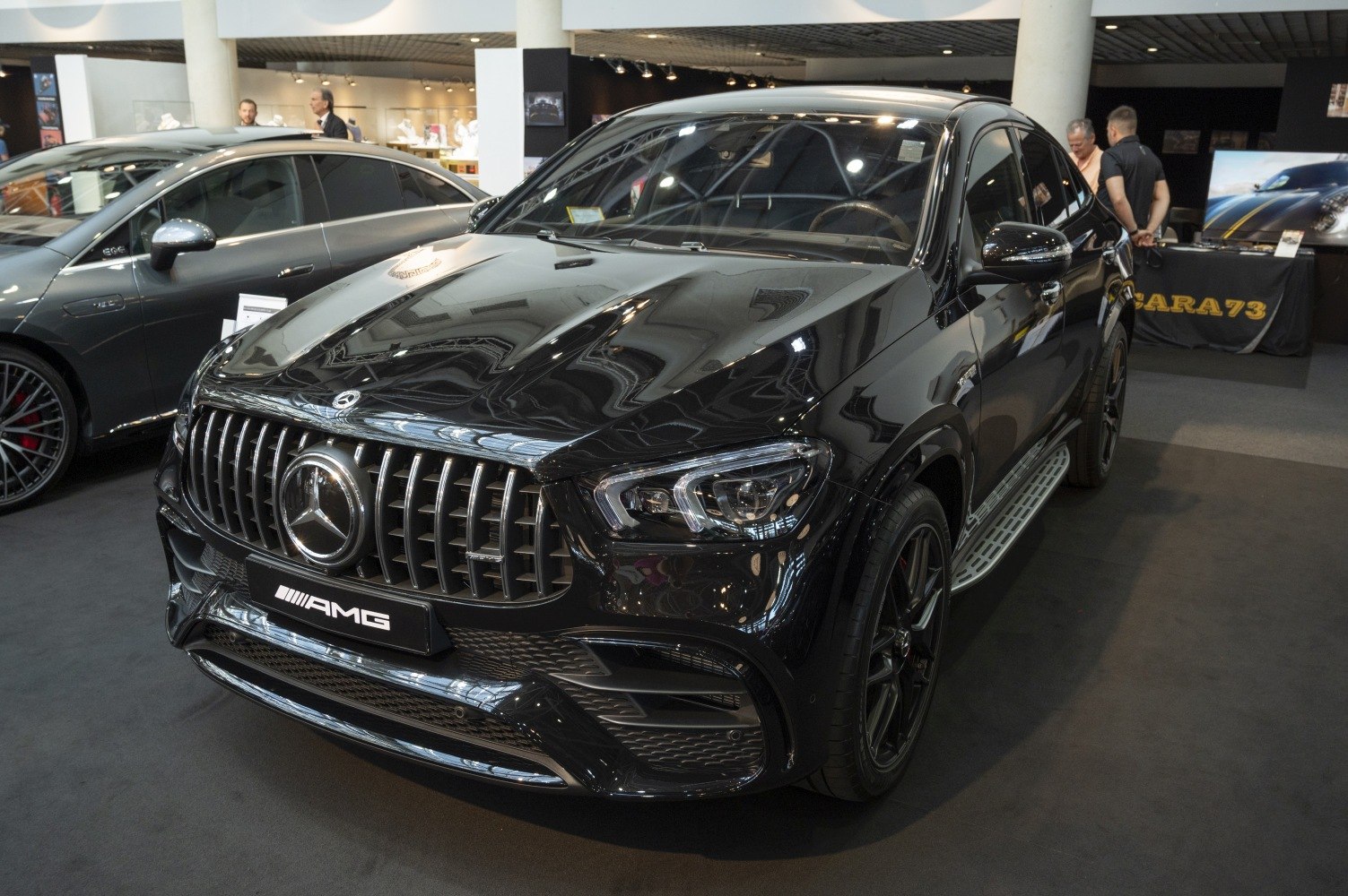 AMG vertical grille and modern headlight design on black SUV coupe