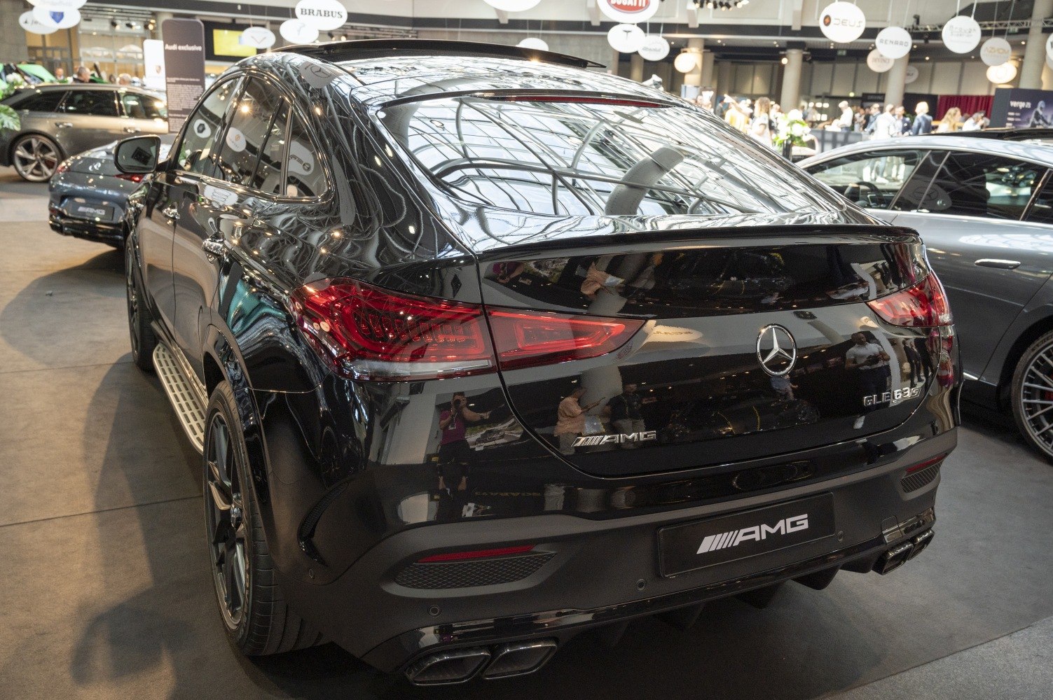 Rear view with sleek taillights and quad exhaust of a black SUV