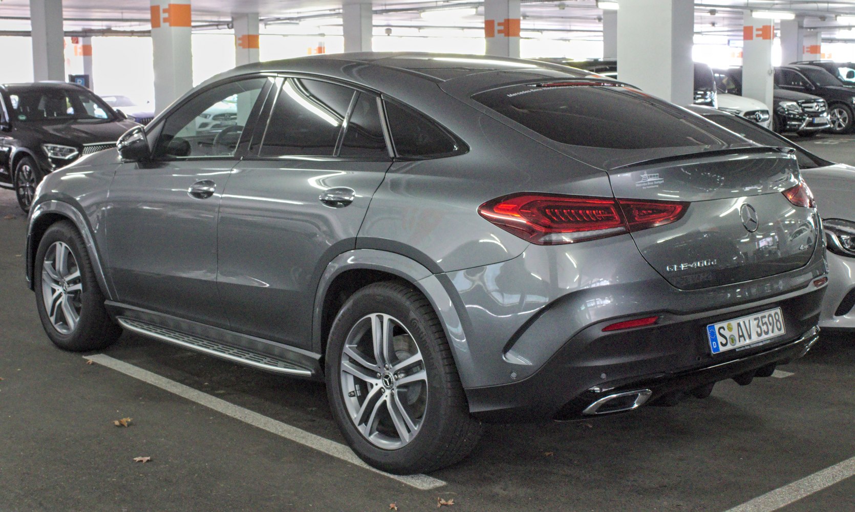 Rear side view of a sleek SUV coupe with distinctive taillights