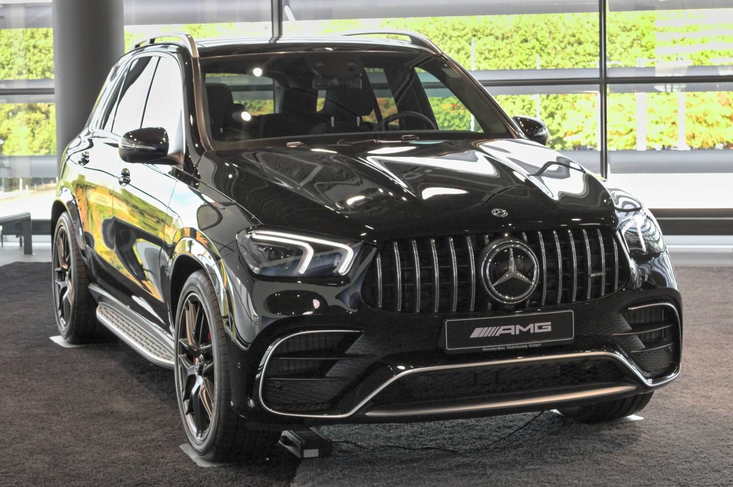Close view of AMG front grille and LED headlights.