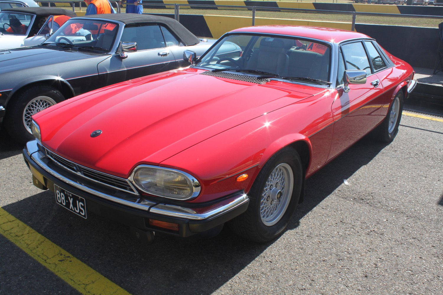 Classic coupe with chrome bumper, distinctive headlights, and alloy wheels