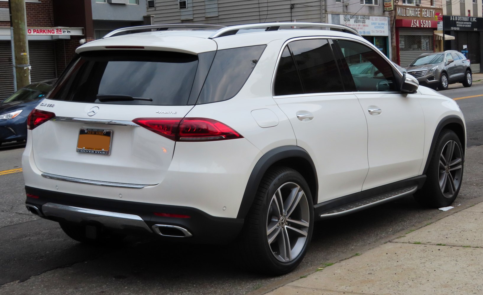 Modern rear view of luxury SUV with alloy wheels and roof rails