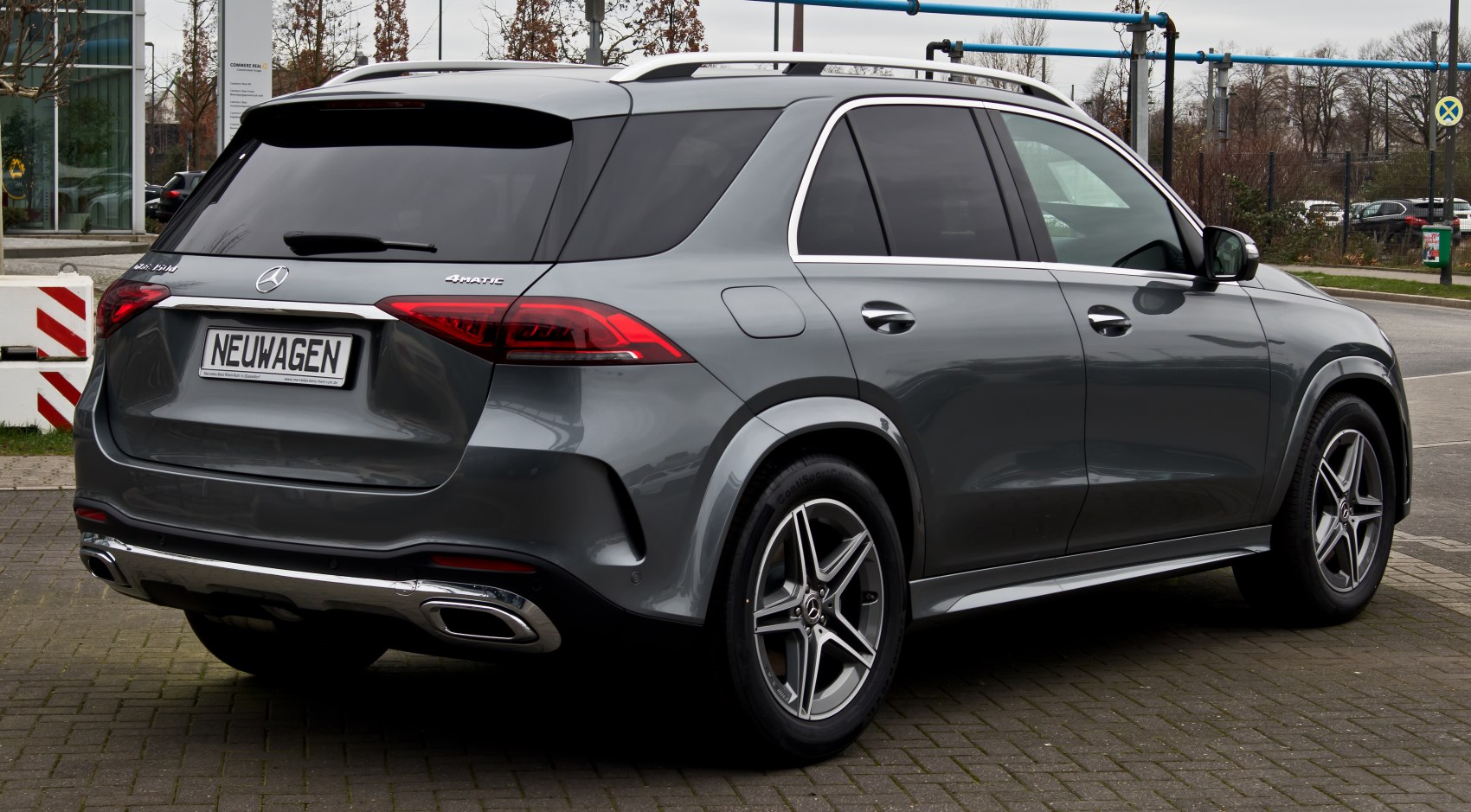 Rear side view of a modern luxury SUV with LED taillights and alloy wheels.