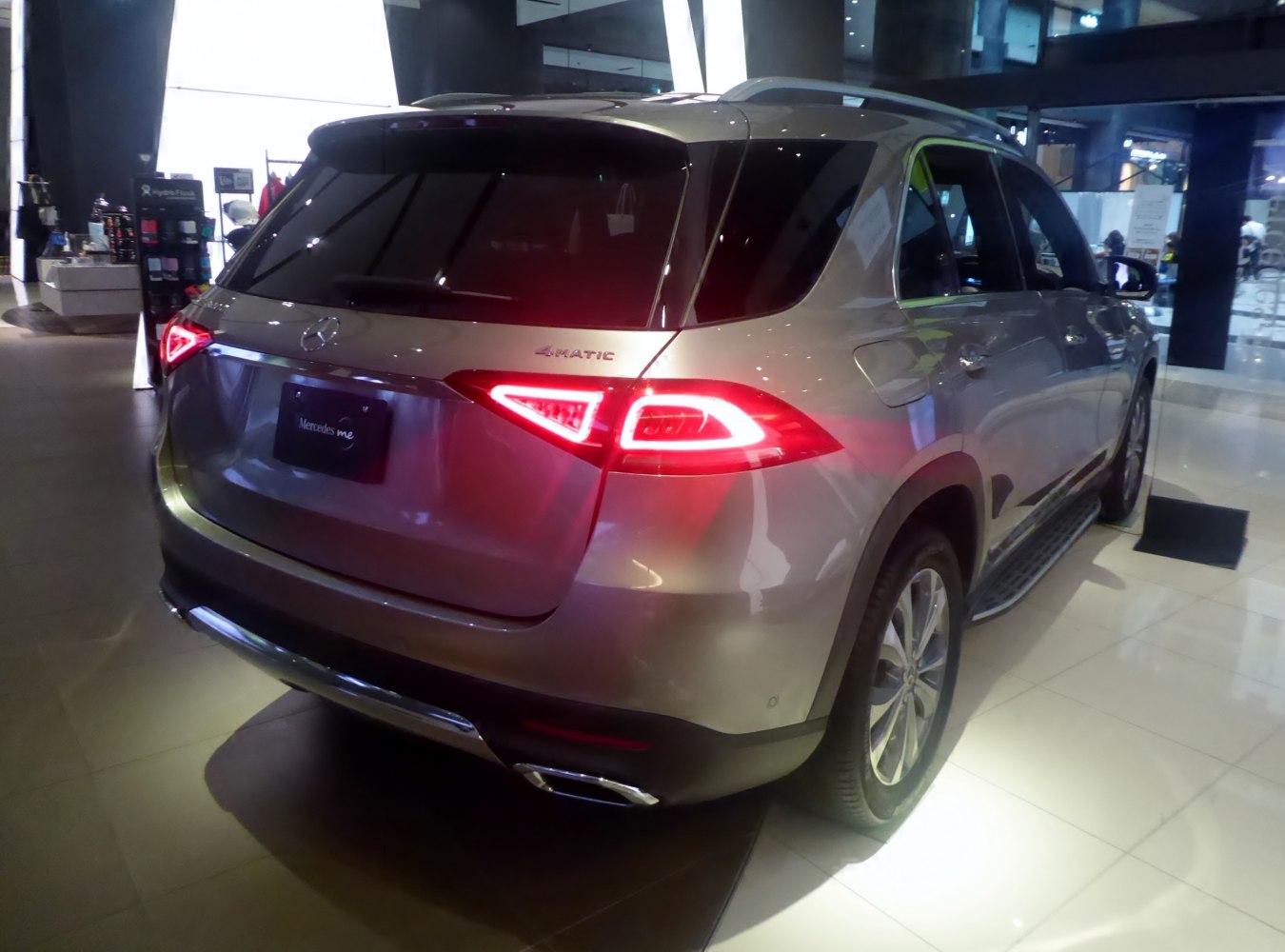 Rear view with illuminated taillights and 4MATIC badge on SUV