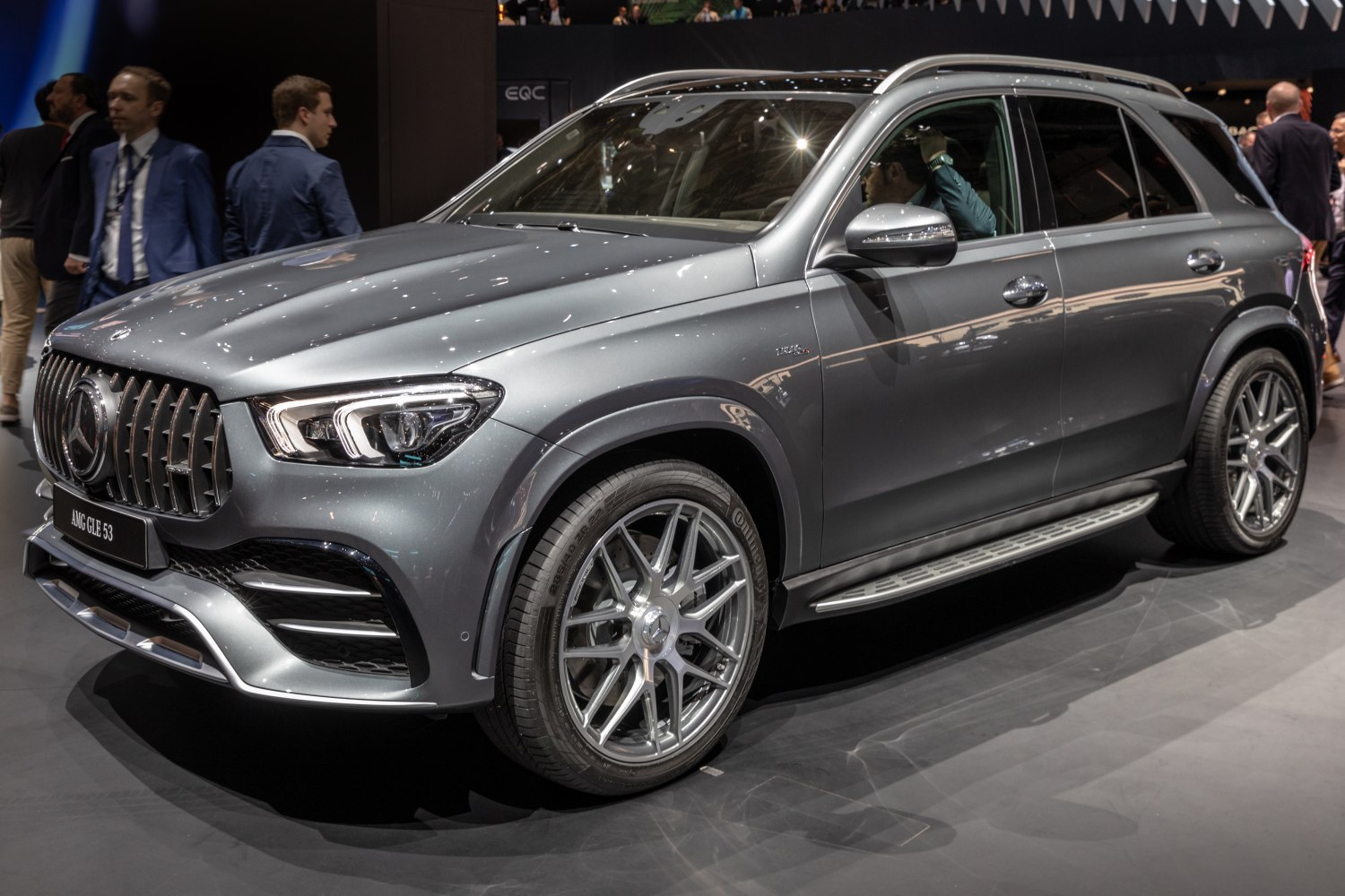 Front and side view of luxury SUV featuring bold grille and alloy wheels.
