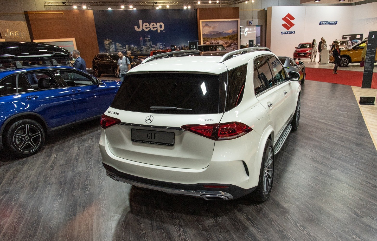 White luxury SUV rear with AMG Line taillights and dual exhausts