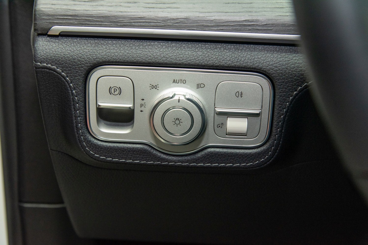 Headlight, fog light, and parking brake control panel with leather trim