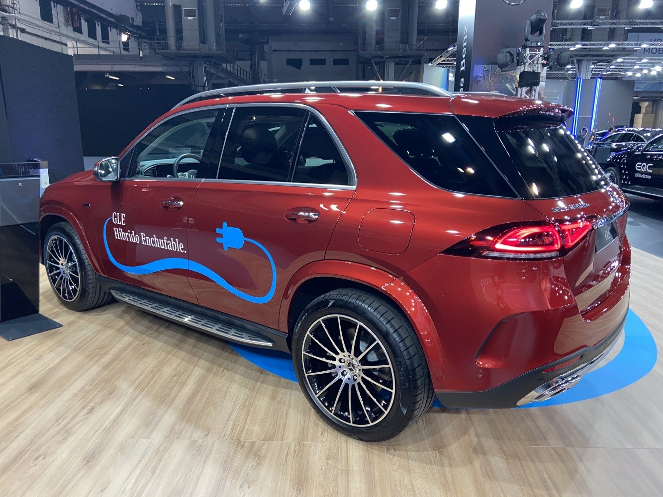 Red plug-in hybrid SUV with alloy wheels, roof rails, and distinctive taillights