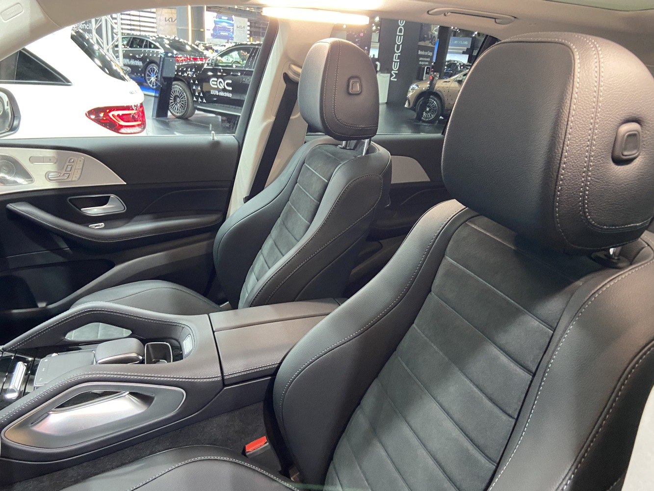 Black leather and suede sport seats with detailed stitching and door panel controls