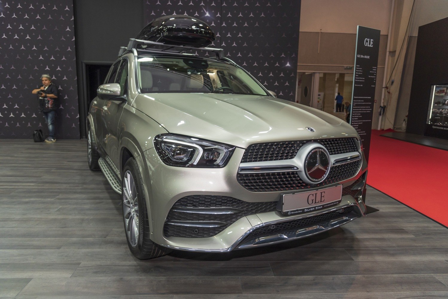Front view of SUV with prominent grille and roof storage box