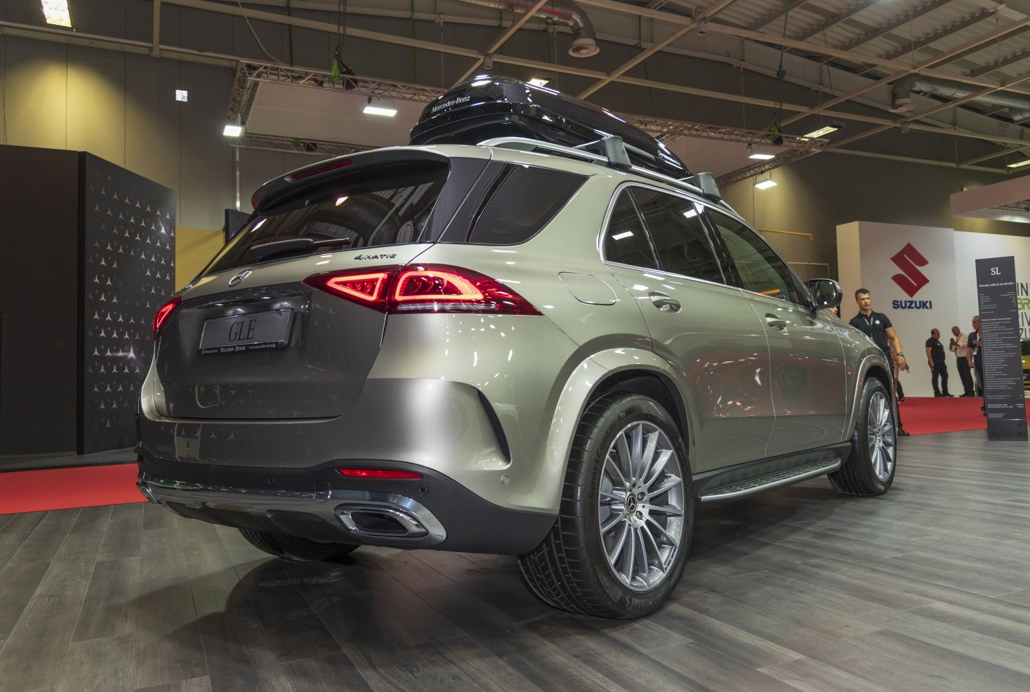 Luxury SUV rear side with alloy wheels and rooftop cargo box
