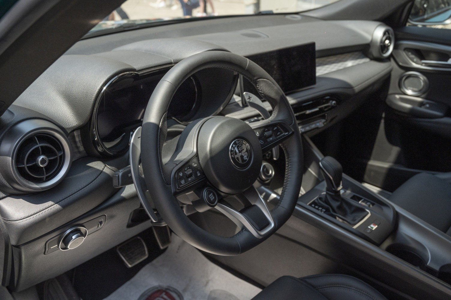 Sporty steering wheel and digital dashboard in a modern car interior
