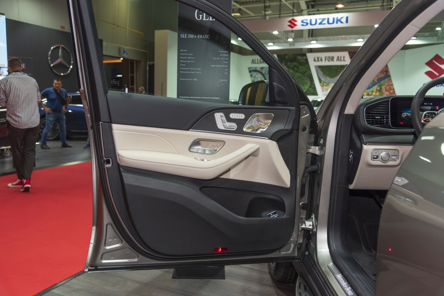 Luxury interior door panel with controls and speaker grille.