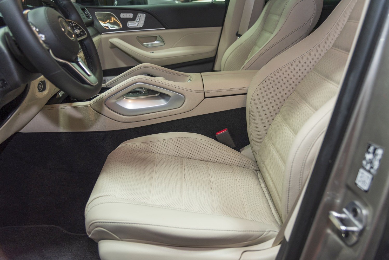 Beige perforated leather seat and modern center console with control buttons