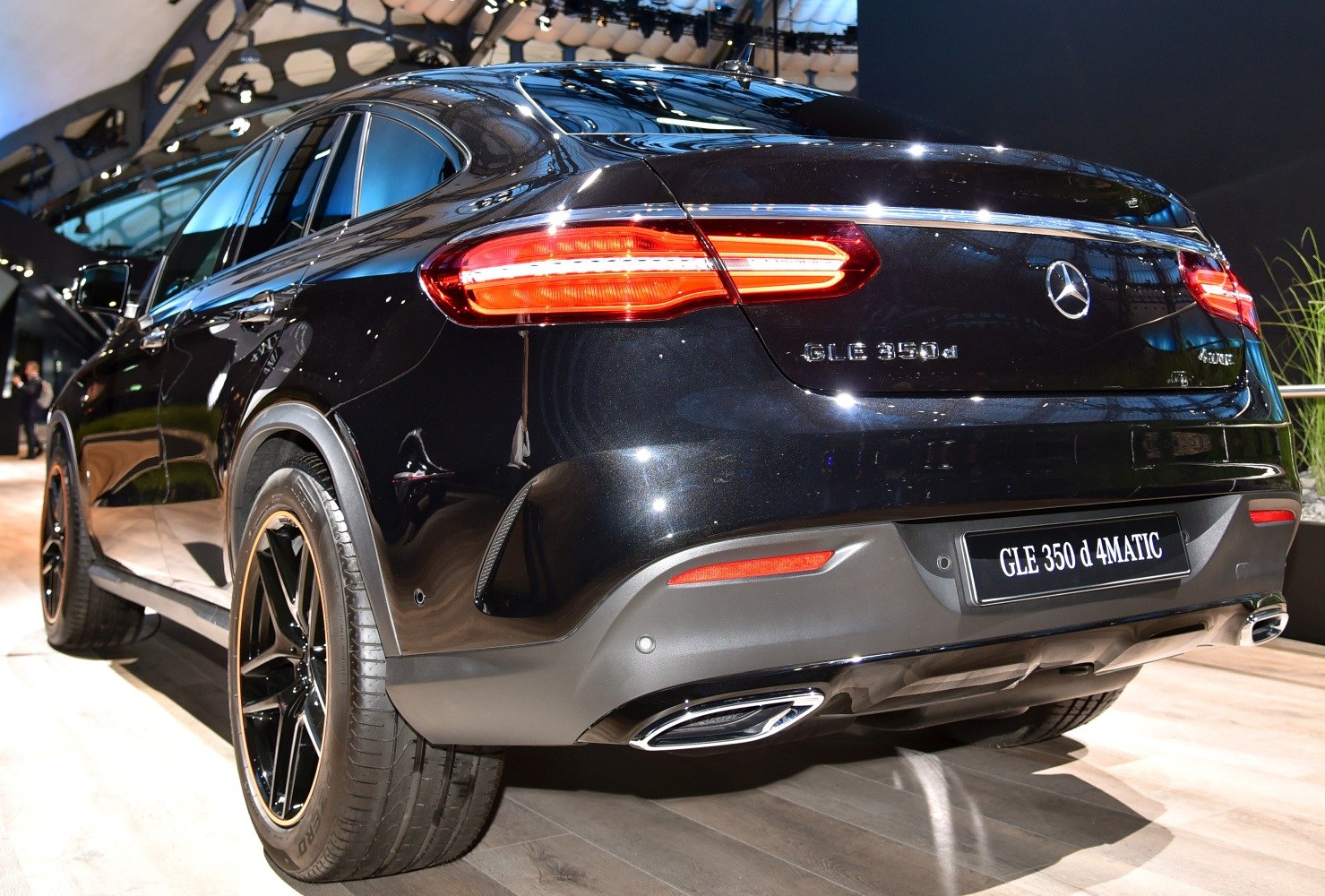 Rear view of a sporty coupe SUV featuring LED taillights and dual exhaust