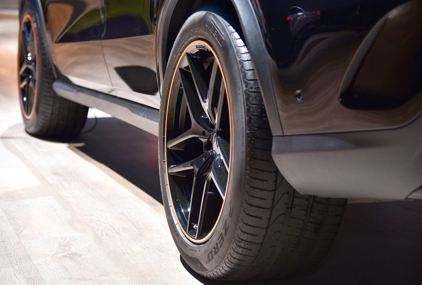 Black alloy wheel with orange rim detail on SUV