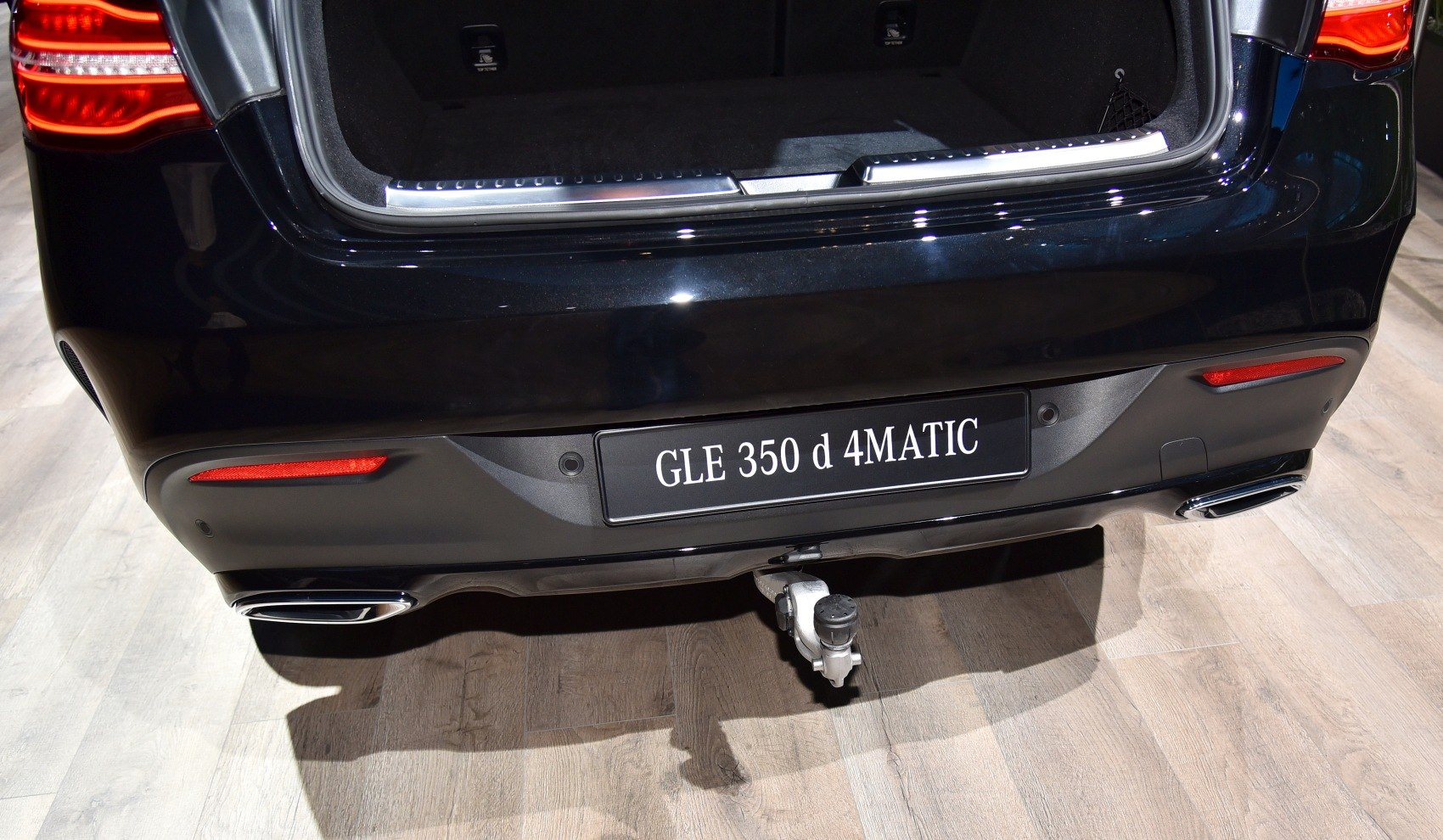 Rear end with open trunk and tow hitch