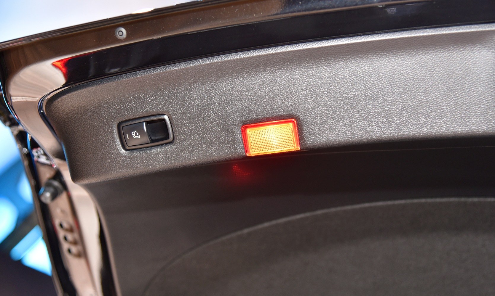 Electric seat folding button and illuminated interior tailgate light
