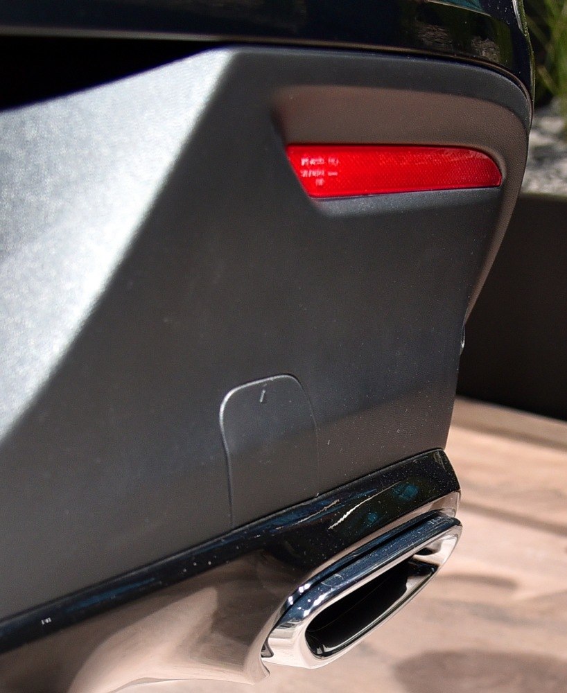 Close-up of rear tail light and chrome exhaust tip
