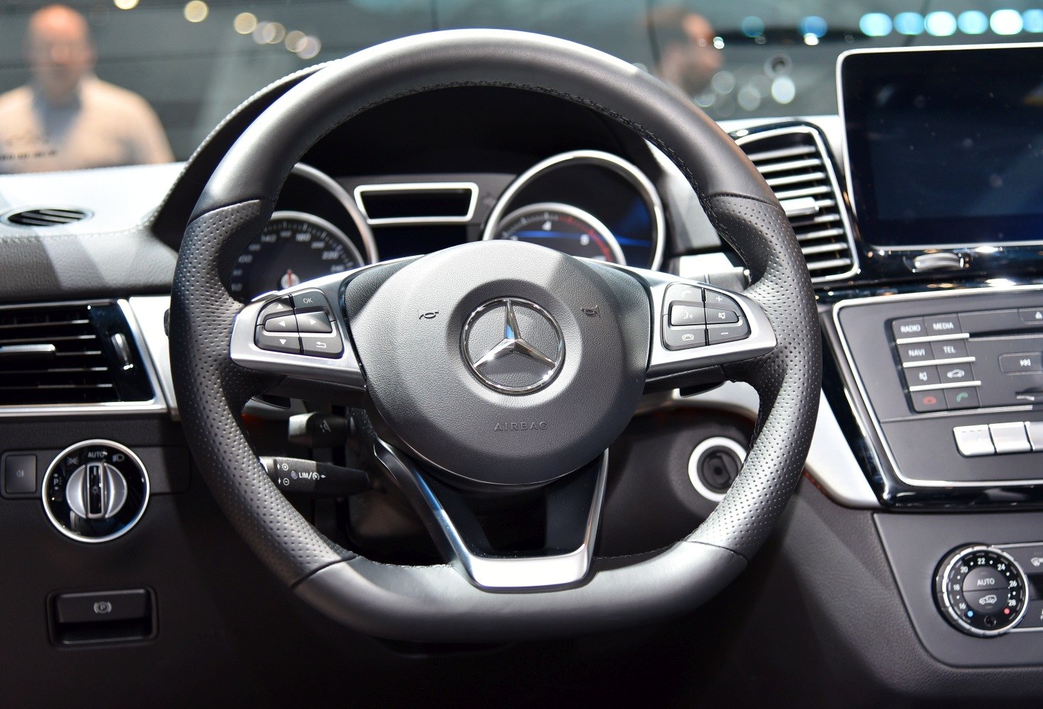 Steering wheel and dashboard controls inside a car